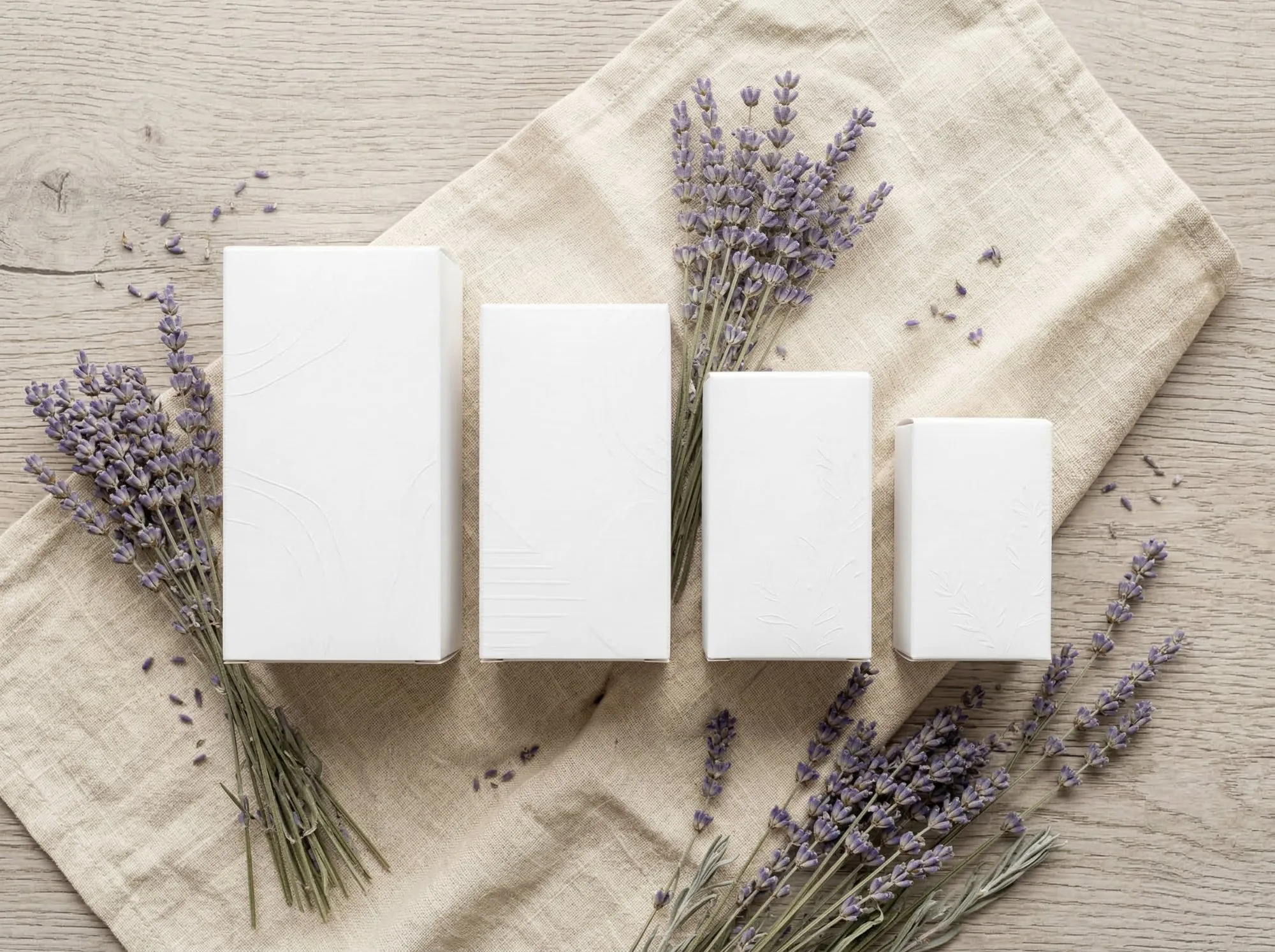 Four matching white folding cartons in graduated sizes